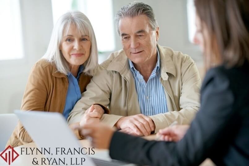 An older couple talking to an attorney